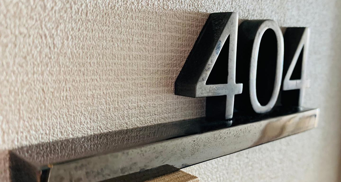 Nina Hotel door sign with number 404 in black