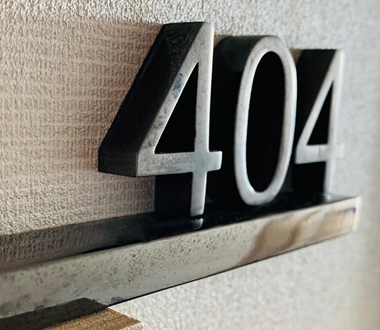 Nina Hotel door sign with number 404 in black